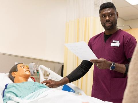 student in health lab with manikin