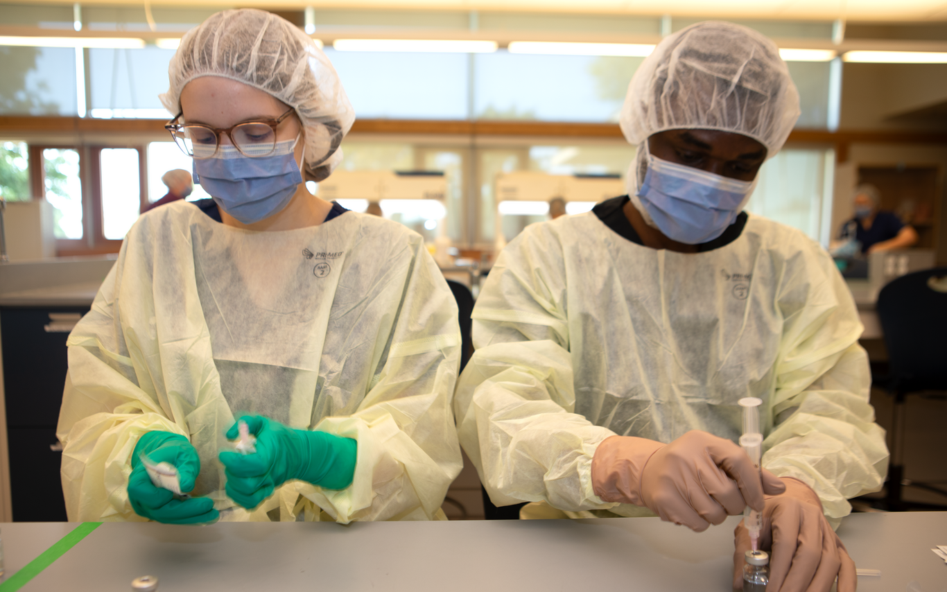Two students working in a lab. 
